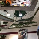 Mirror, palm leaf and lights mounted on a ceiling