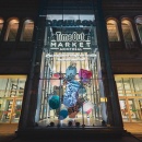 A huge art installation with colored paper in the foyer of a shopping mall;...