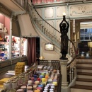 A historic staircase in a building going up on two sides, in front of it...