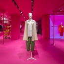 Mannequins and clothes presented inside a pink colored store...