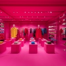 Mannequins and clothes presented inside a pink colored store...