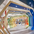 A game store with colorful shop design and rainbow-colored wooden arches as an...