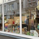 Stuffed bunnies decorate a toy store window.