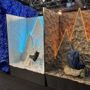 Two different rooms separated by a wall. One is white with a snowy theme and...