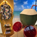 A sandy scene featuring sunglasses and a coconut, with a pair of yellow...