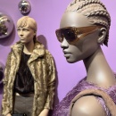 Two modernly dressed mannequins wearing fashionable accessories and sunglasses...
