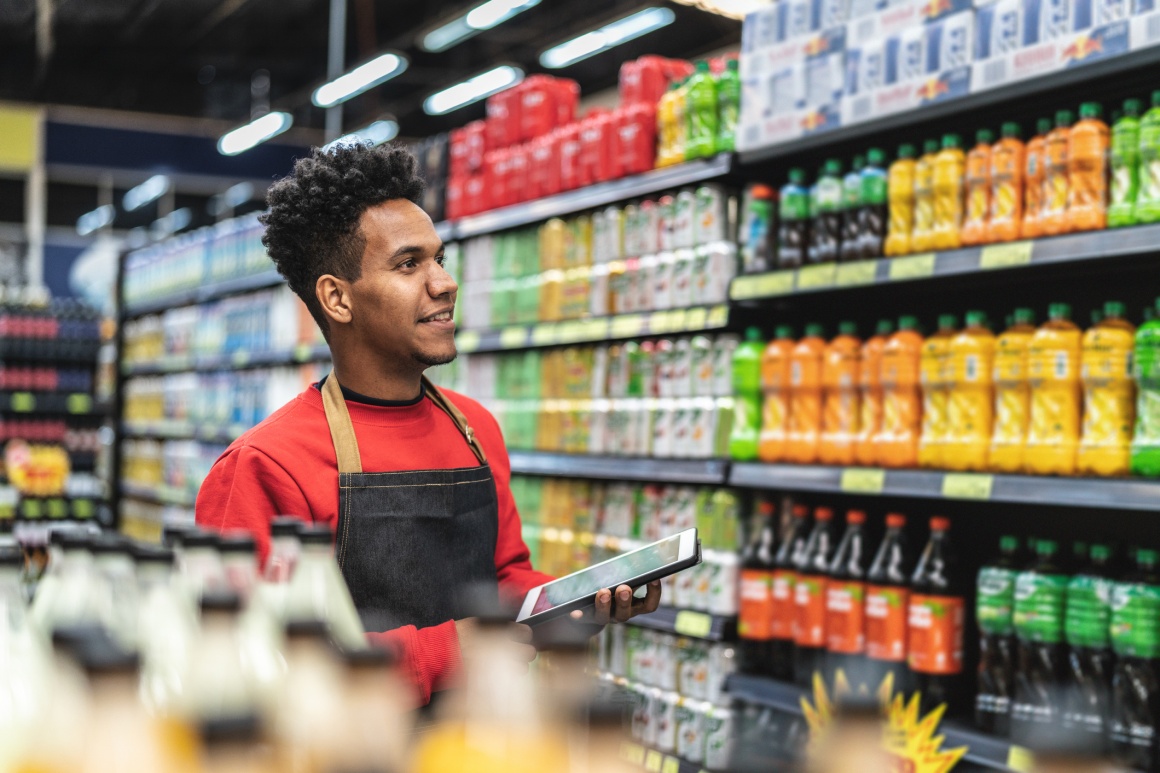 Employee in a supermarket with a tablet