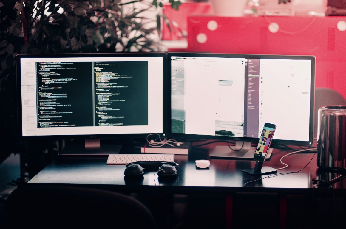 Two computer screens on a desktop