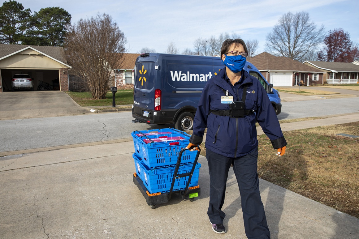 Woman goes with delivery to home entrance