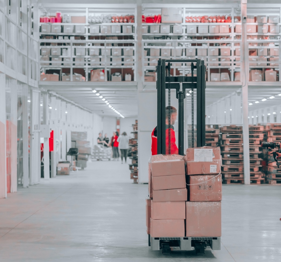 A man carrying packages with a forklift; Copyright: Jake Nebov/Unsplash...