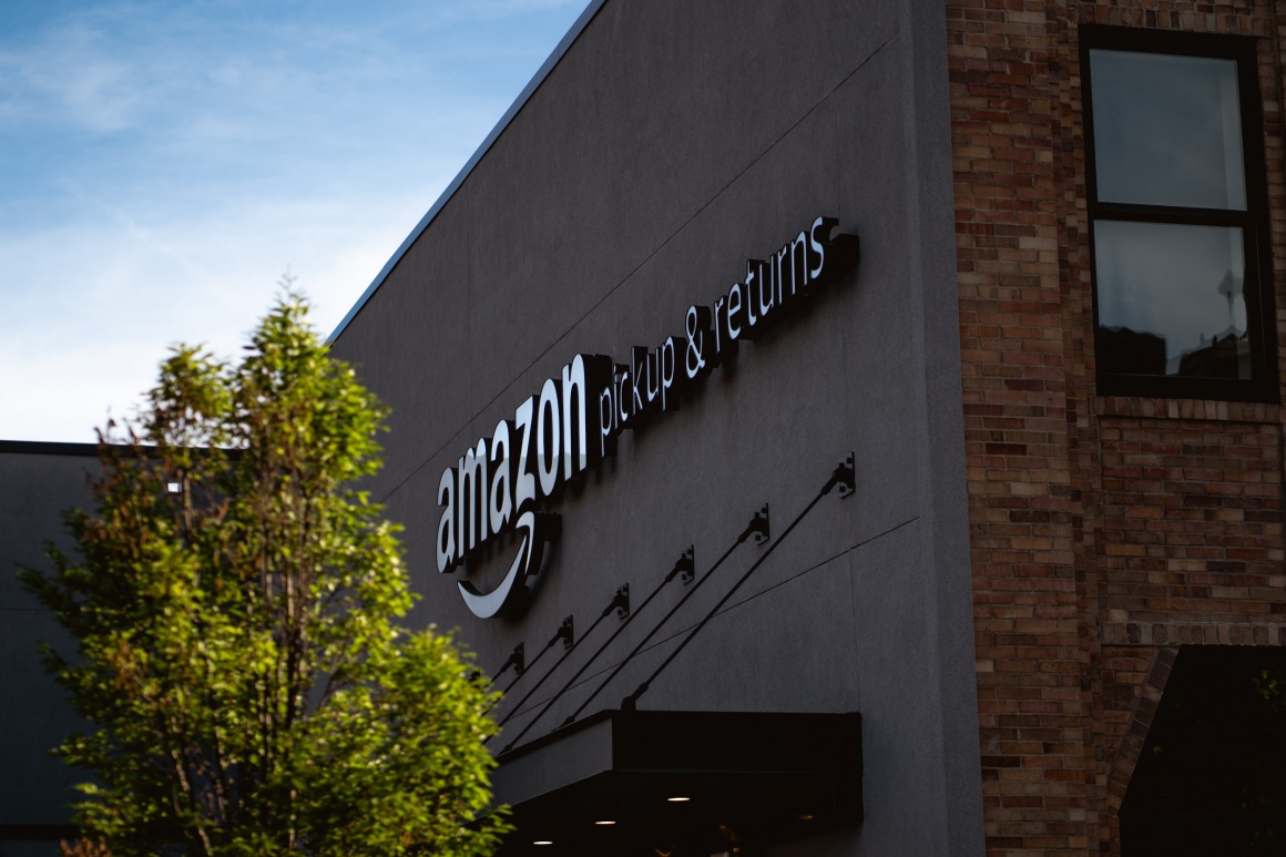 A building with writing amazon pickup & return on its side...