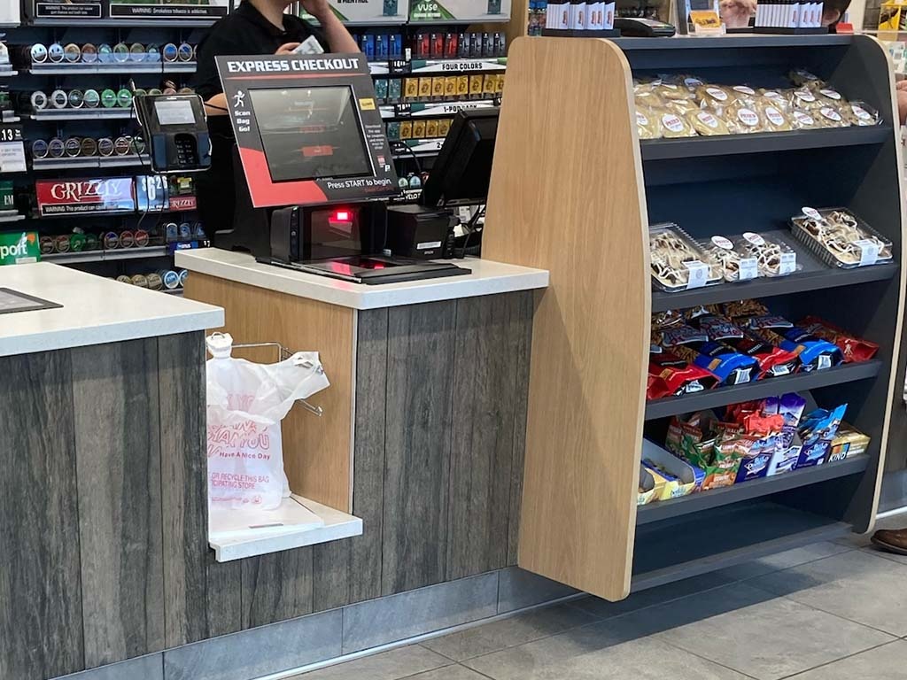 A self checkout counter in a convenience store; copyright: Pete’s of Erie Inc....