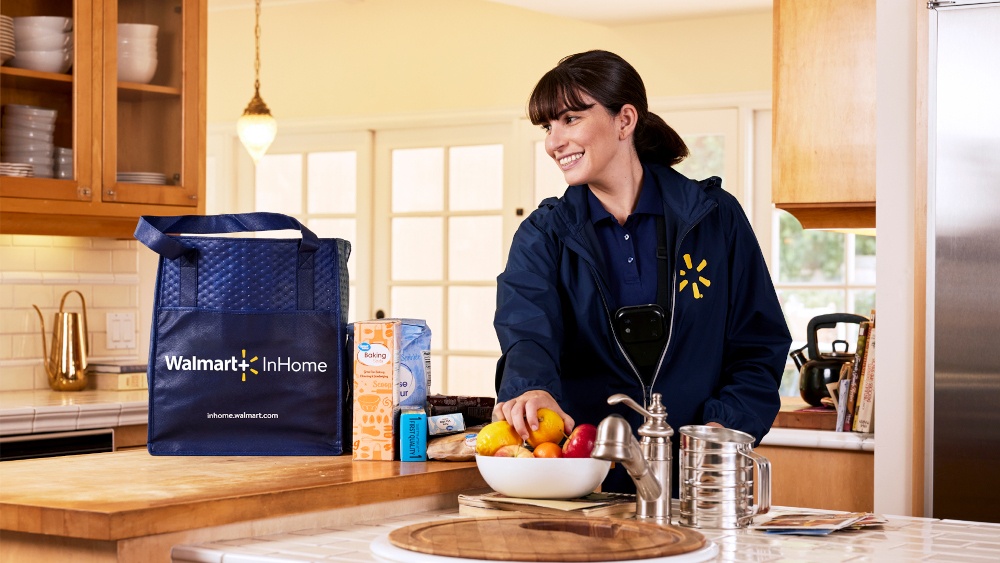 A walmart delivery woman standing in a customers kitchen with groceries:...