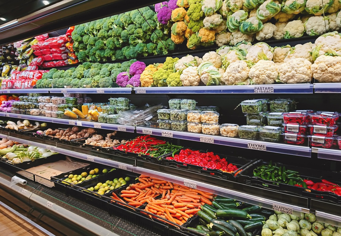 A vegetable shelf with different types of vegetables...