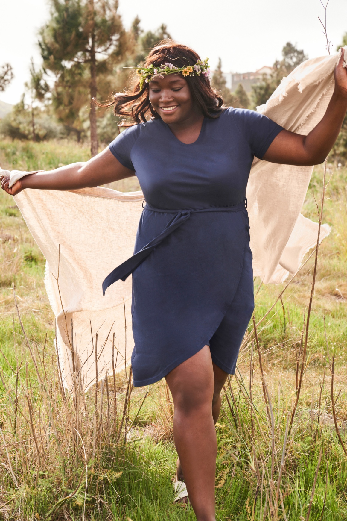 Person with blue dress on a green field