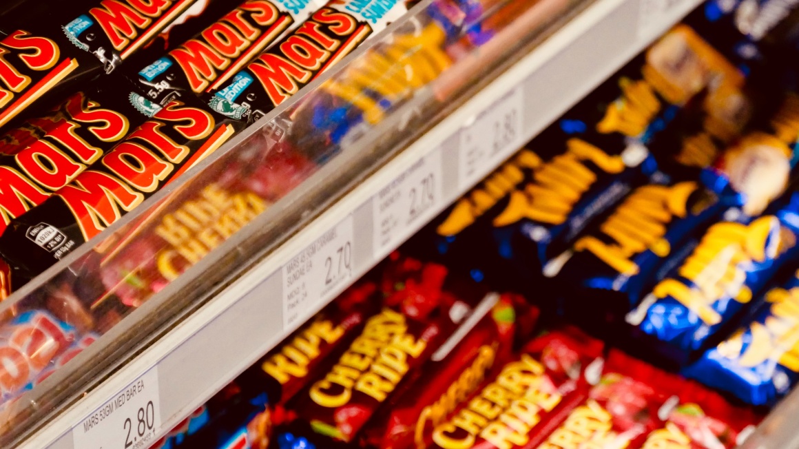 Candy bars on a shelf in a supermarket