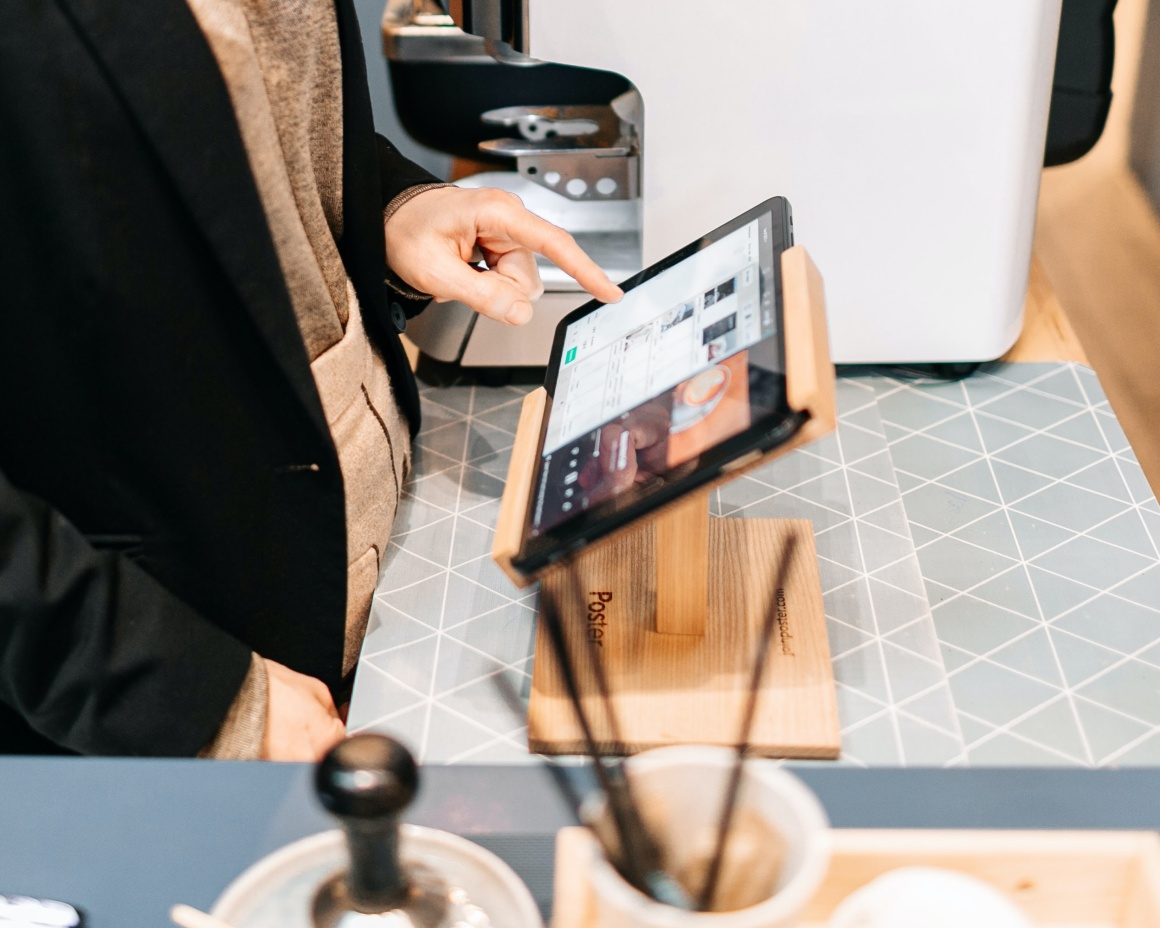 A person uses a tablet for checkout