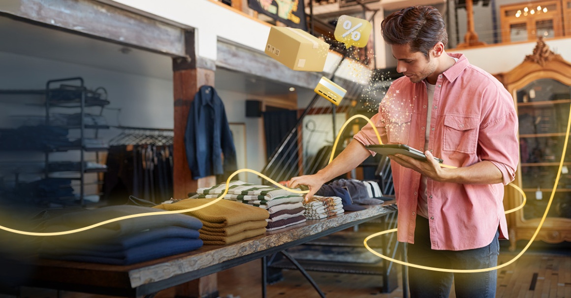 Person in fashion store with smartphone in hand