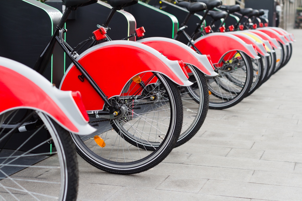 Several identical looking bikes are parked next to each other....