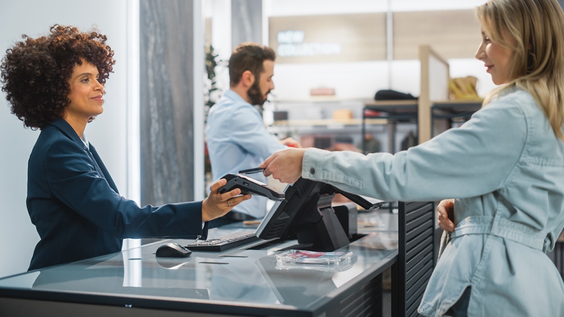 A person uses a smartphone to pay at a card reader