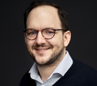 Portrait of a smiling man with glasses on