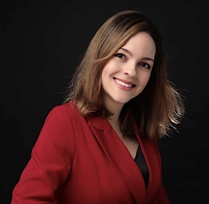 Woman with long brown hair wears a red top