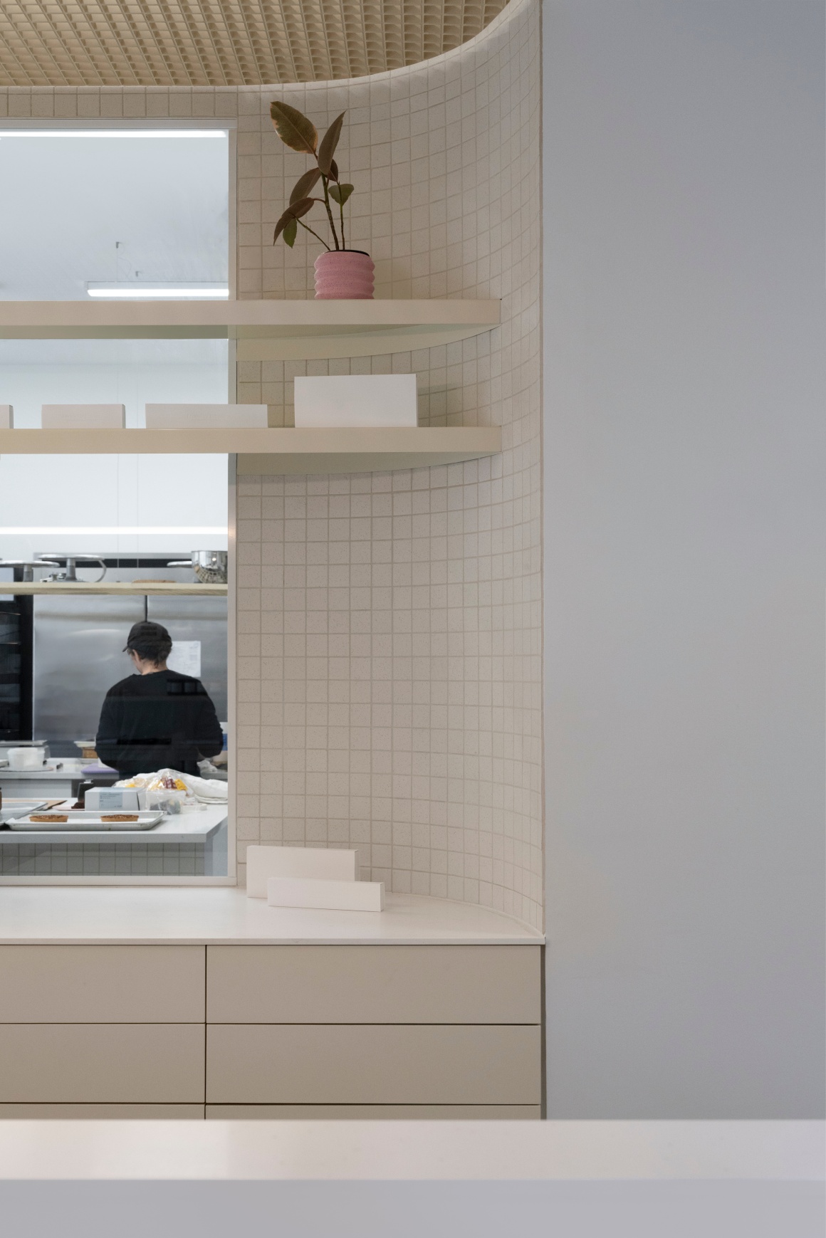 A window that allows a view into the kitchen.