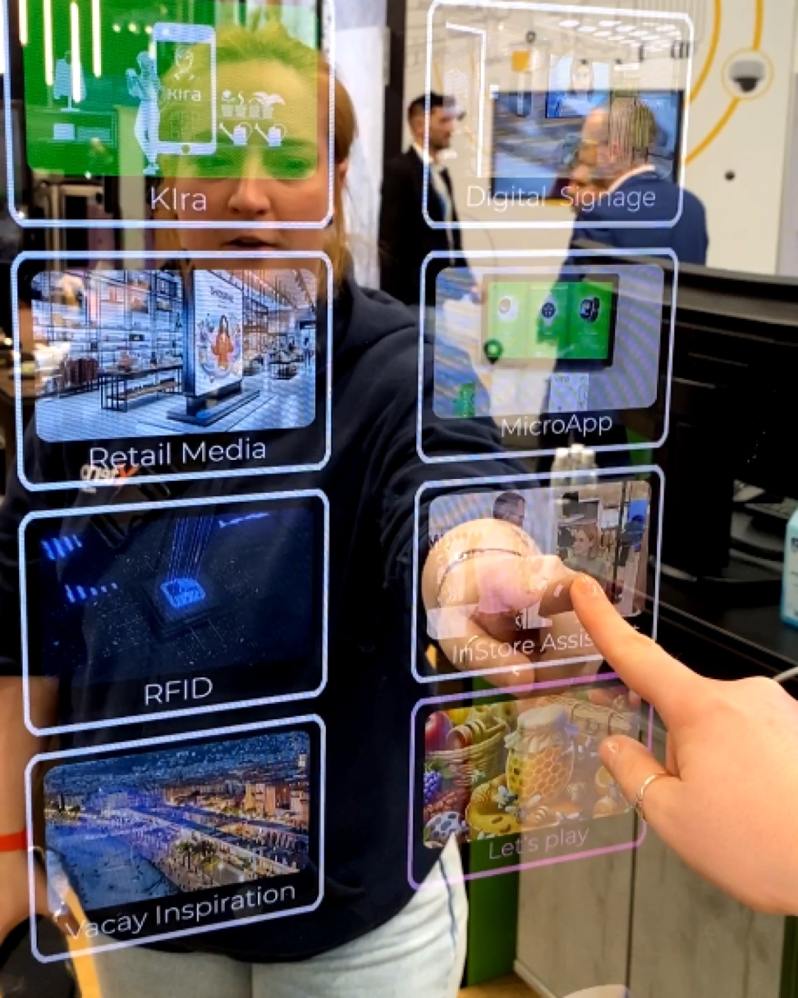 One person operates the touch mirror with the integrated Kira app...