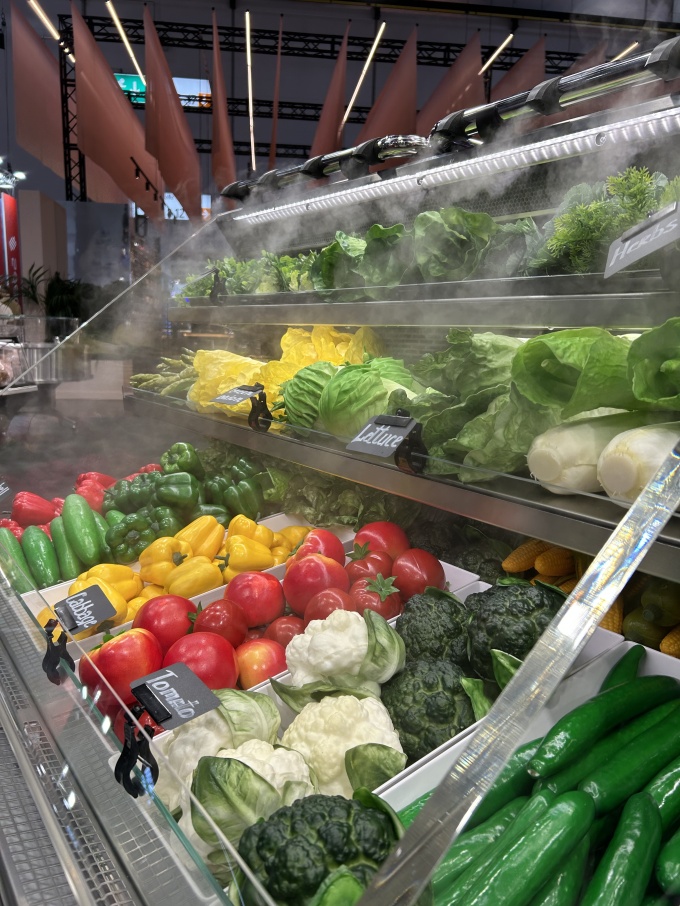 Refrigerated display cases with a fine mist of water on fresh-looking...