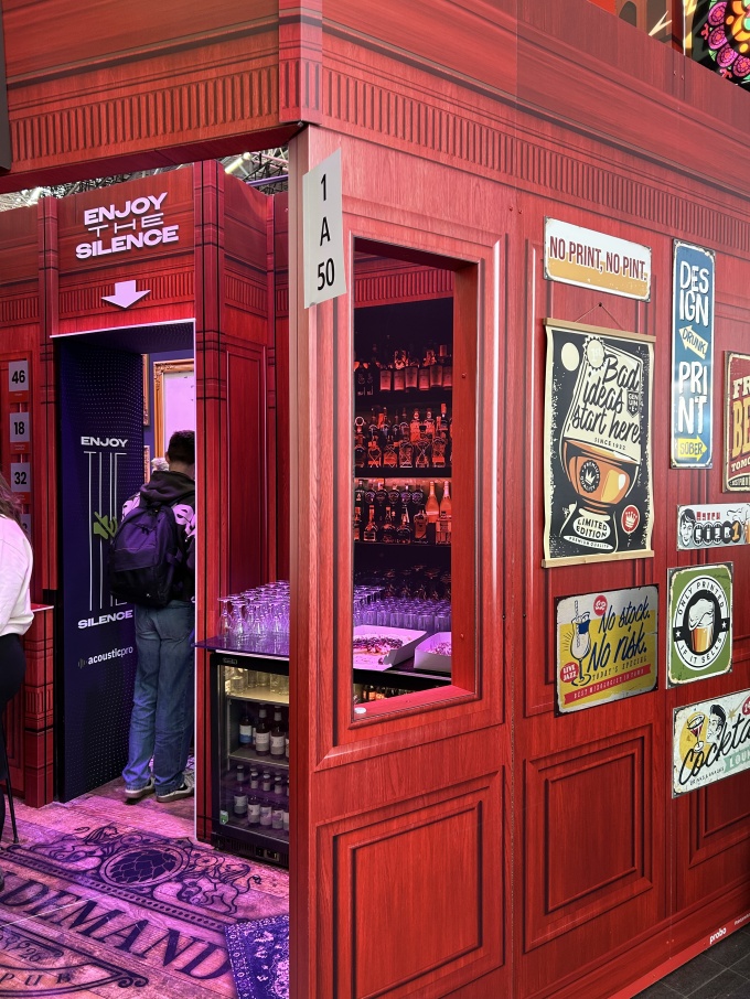 A red room façade with a wooden aesthetic and pictures on the wall, with the...