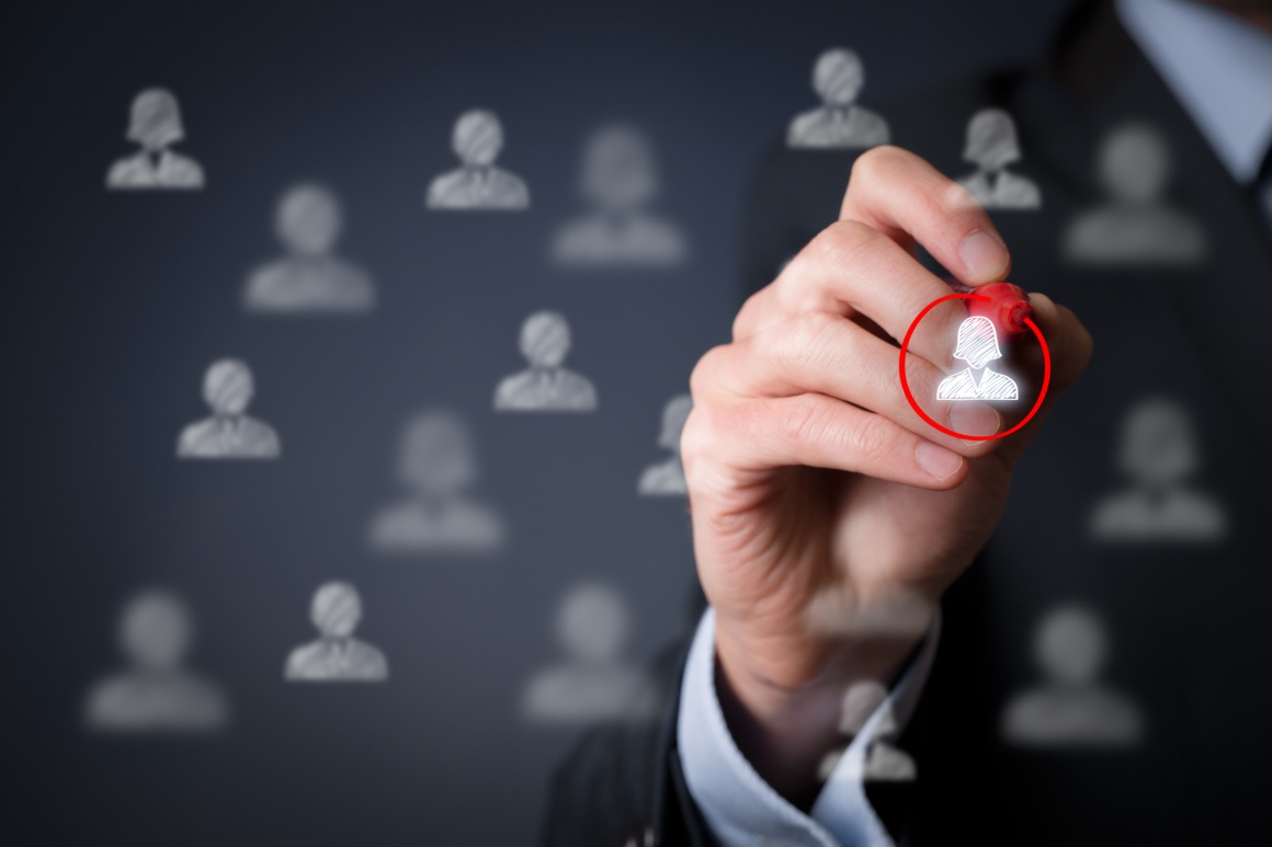 Photo: Man in suit circling people icon with red marker; copyright:...