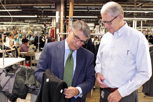 Two men with clothes in store