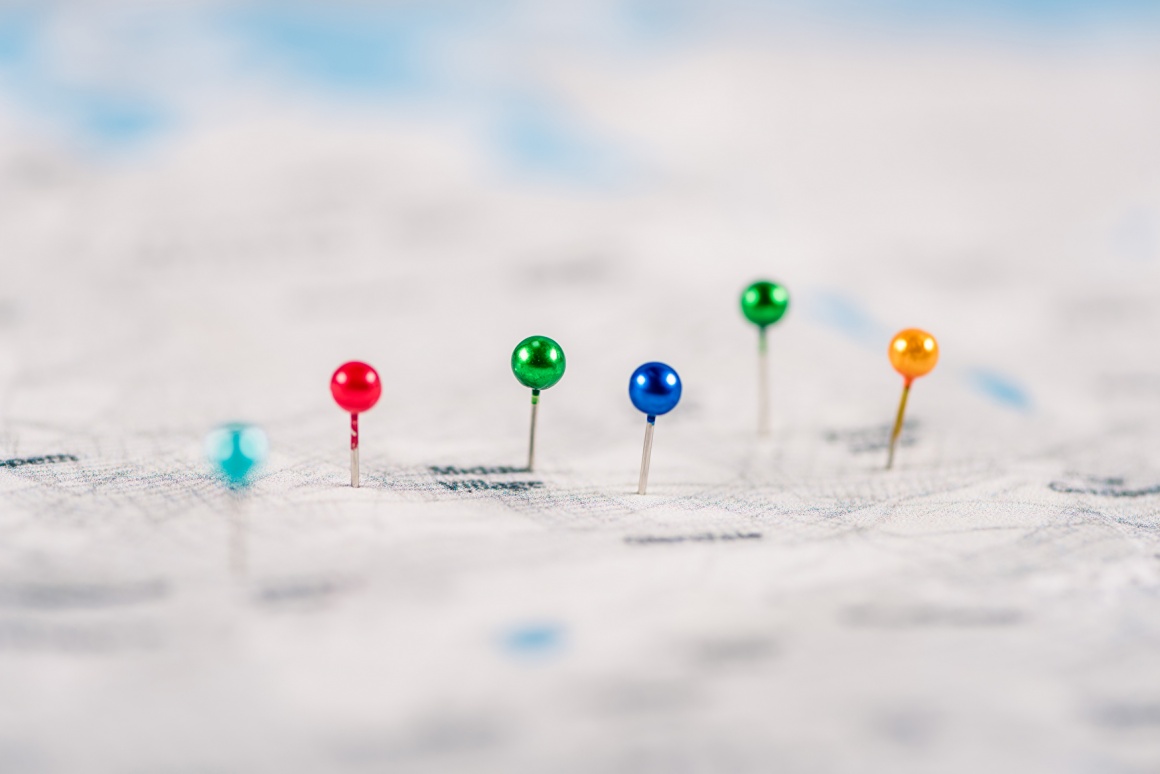 Several colored pins sticking in a paper map; copyright:...