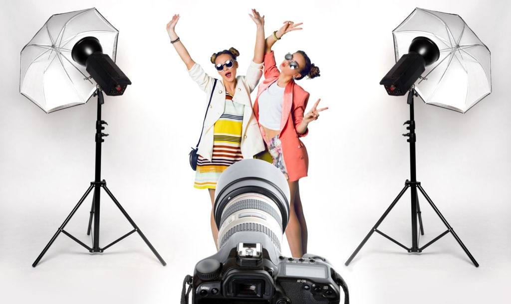 Two women in a photo studio in front of the camera....
