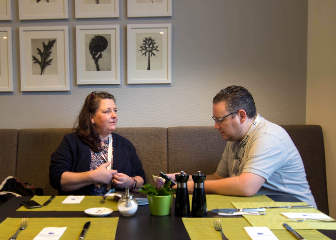 Woman and man sitting at the table during a conversation...