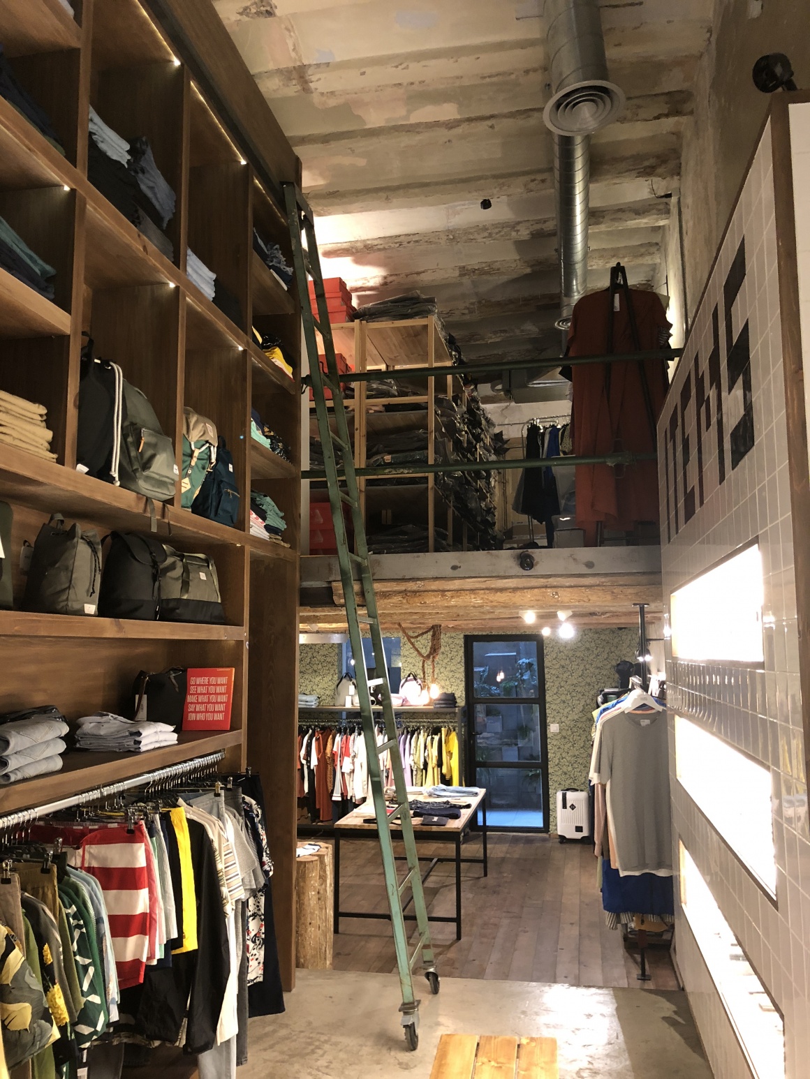 View into a small shop with a shelf on the left, a showcase on the right and...