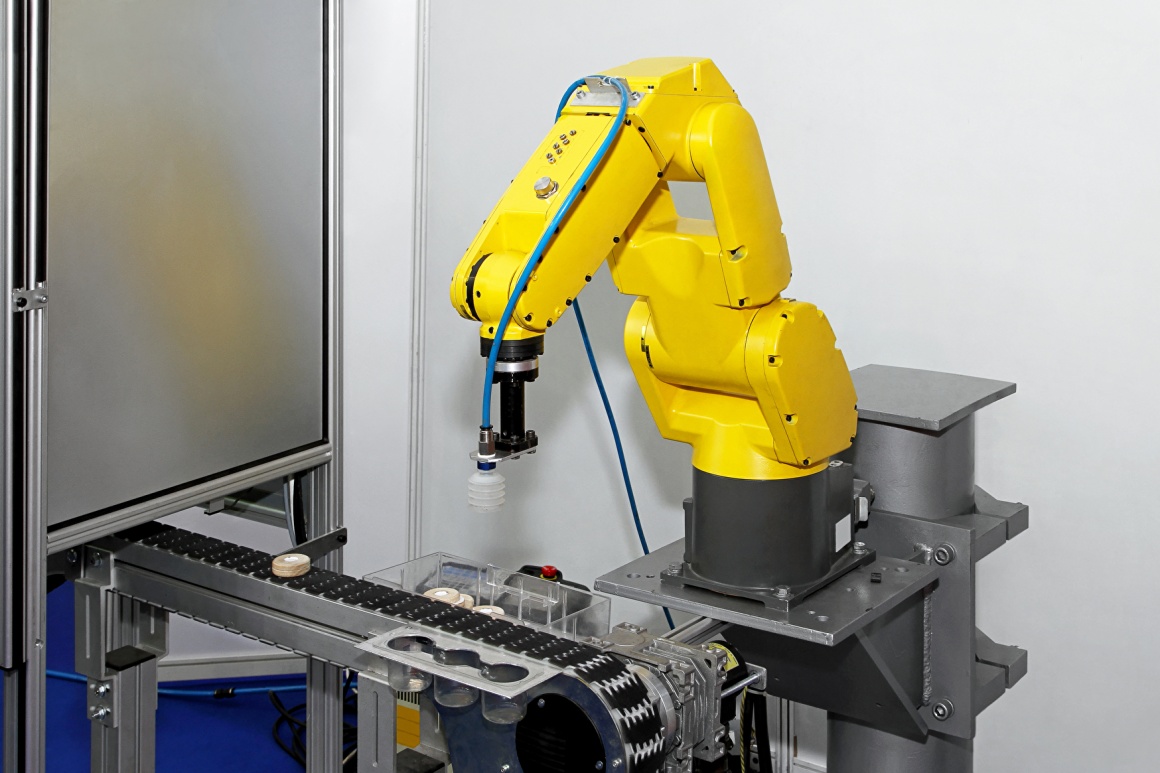Yellow robot arm in an industrial production plant; copyright:...