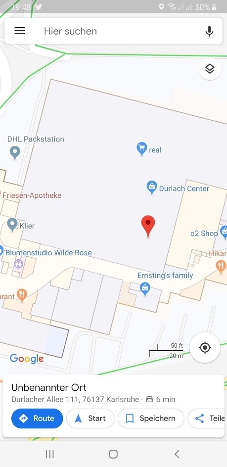 Mobile screenshot of Google Maps with shops and a location pin...