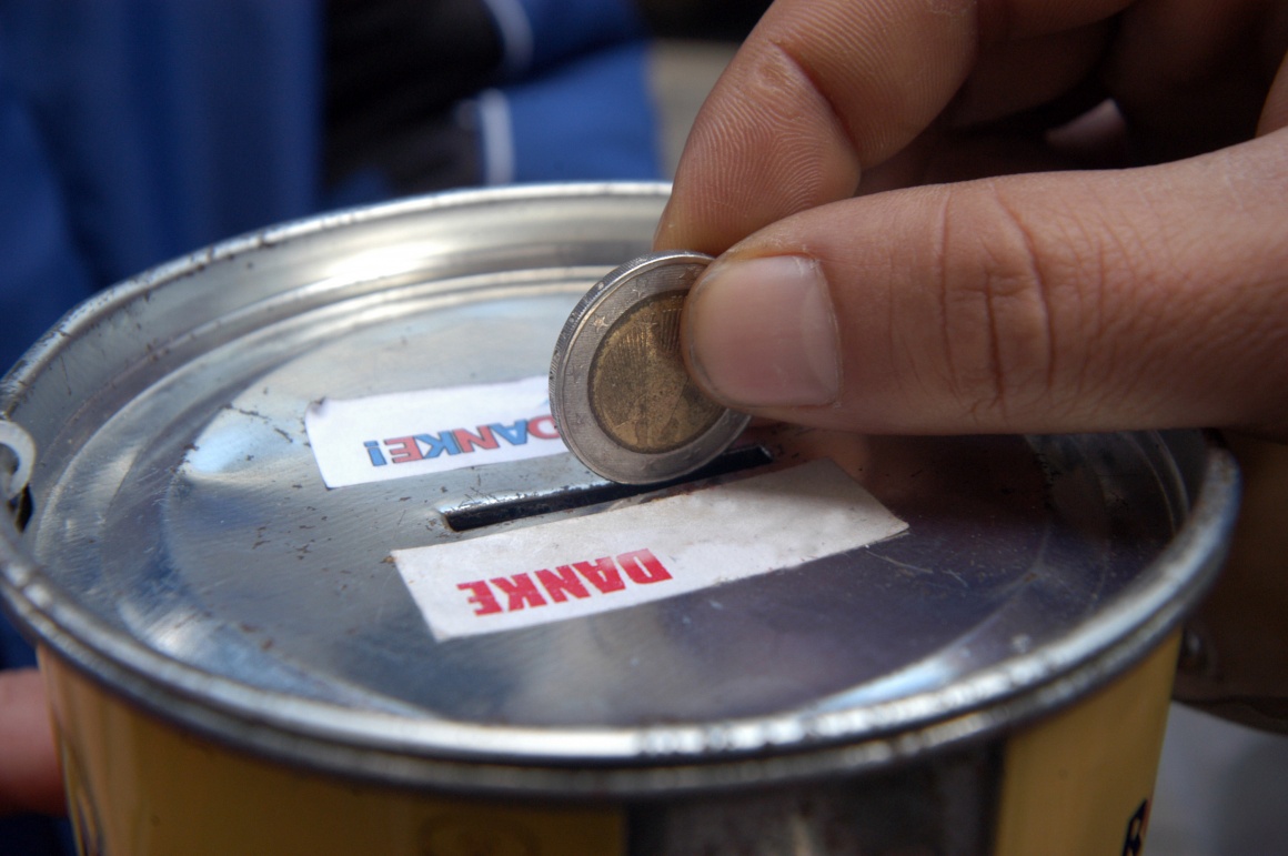 Hand that throws money into a donation box