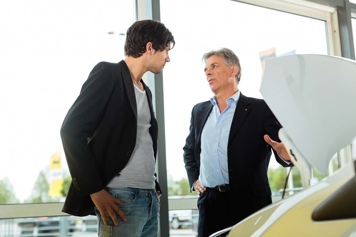 A salesman offers a car