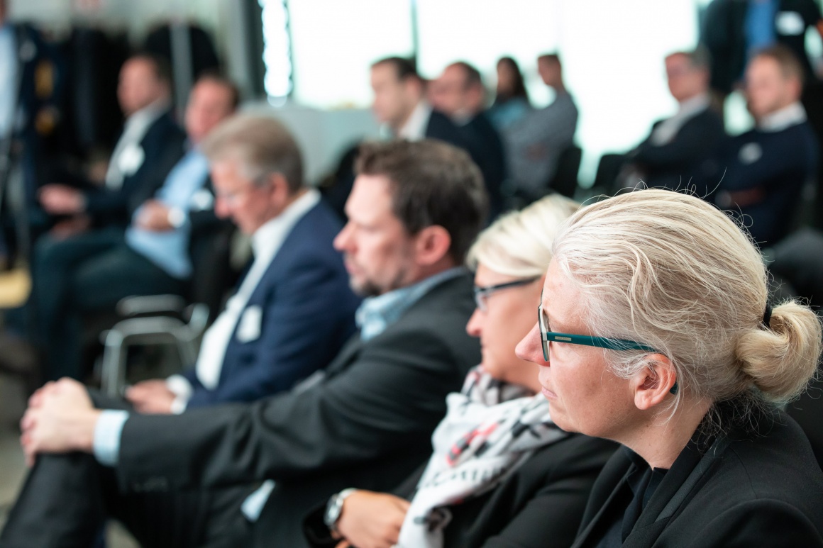 View of a listening audience in suits