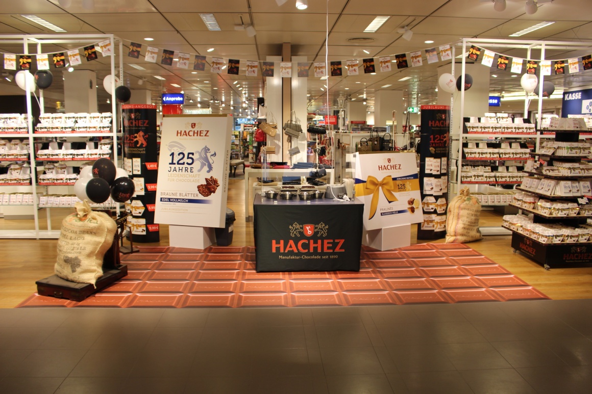 An advertising space for various chocolates in a department store with a floor...