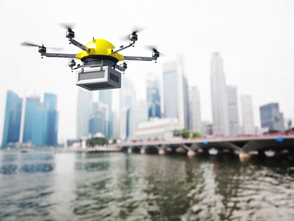 A delivery drone over water in front of skyscrapers...