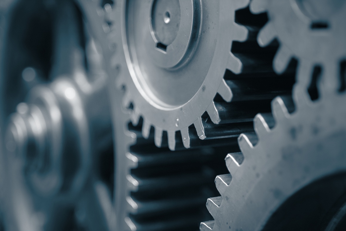 Close-up: Several steel gear wheels mesh together