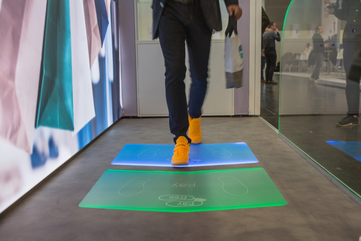 A man walking on green and blue fields