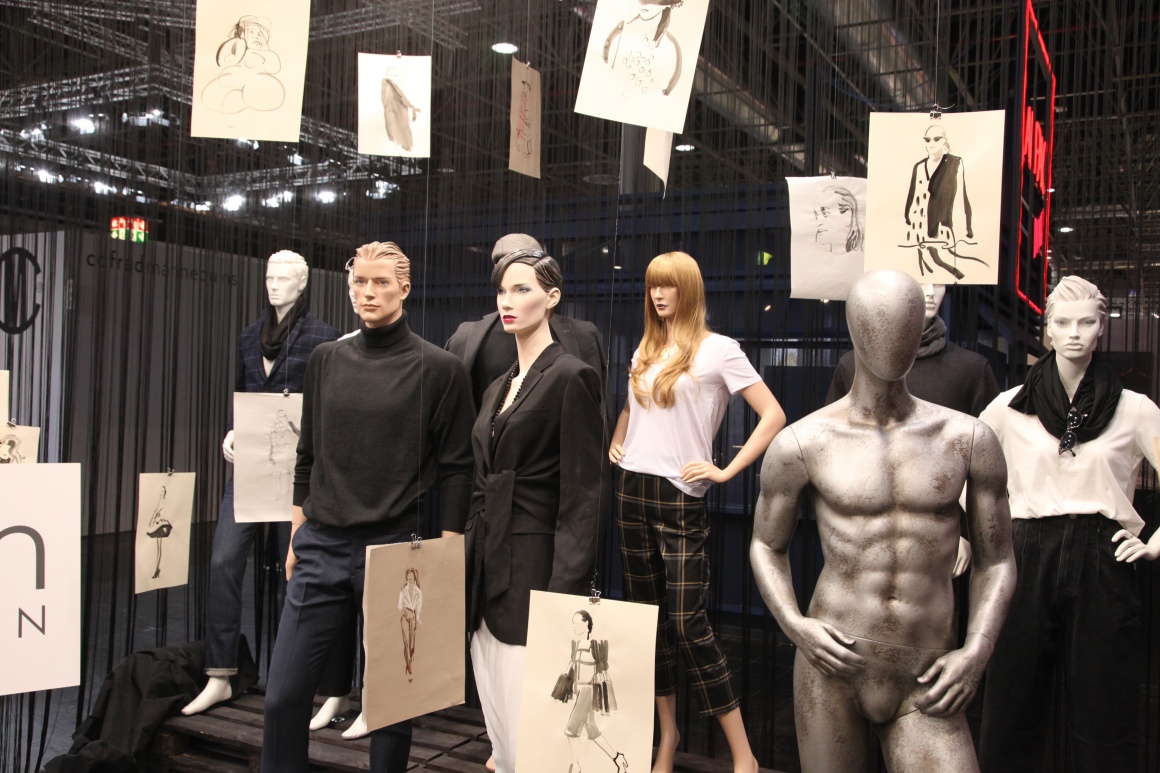 Mannequins standing between posters