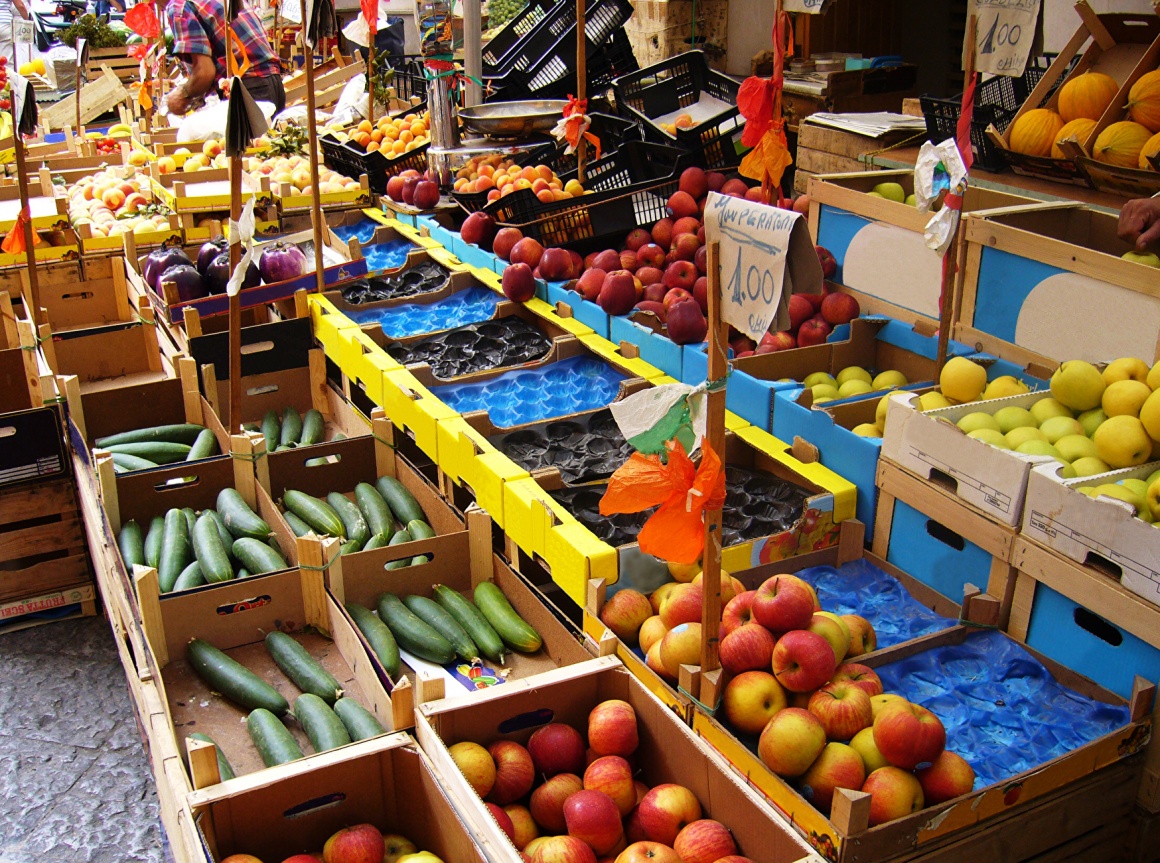 Market stand outside with fresh fruits and vegetables...