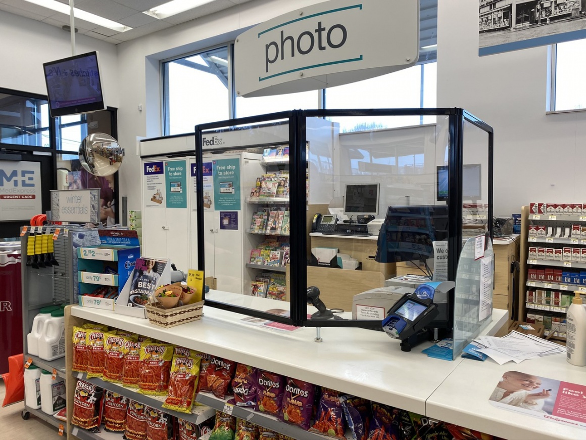 A counter in a store with a transparent shield