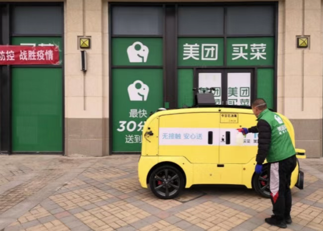 A man in front of a small yellow car