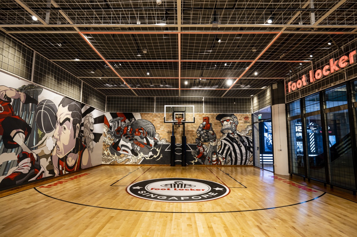 A basketball court with murals on the wall